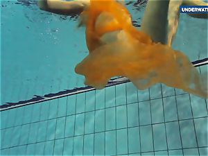 Yellow and red clad teenage underwater